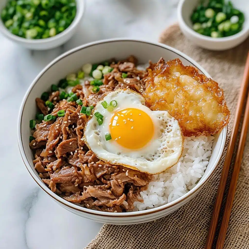 Gyudon Japanese Beef & Rice Bowl, Japanese Gyudon recipe, Easy Gyudon bowl, Authentic Japanese beef rice dish, Japanese comfort food A bowl with three layers is shown: the bottom layer is white rice, the middle layer has cooked thin slices of brown meat mixed with translucent cooked onions, and the top layer is a sunny-side-up egg with a bright yellow yolk and white edges sprinkled with white sesame seeds and some chopped green onions. Next to the bowl, there is a small metal bowl filled with chopped green onions, wooden chopsticks placed on a blue and white chopstick rest, and a large white bowl filled with more cooked meat and onions in the background. The setting is on a white marbled surface with a piece of brown burlap cloth underneath the bowls.