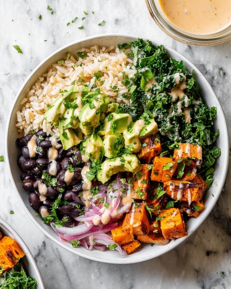 The image shows a white bowl filled with a colorful layered salad on a white marbled surface. The bowl has five main layers arranged side by side: light brown cooked rice on the upper right, dark green chopped kale mixed with thin pale pink onion slices on the lower right, bright orange roasted sweet potato cubes on the lower left, glossy black beans below the sweet potatoes, and light green diced avocado pieces on the upper left. Finely chopped green herbs are sprinkled over the top, and a creamy light-colored sauce is drizzled over the sweet potatoes and beans. A glass bowl with more sauce is visible nearby. Photo taken with an iphone --ar 4:5 --v 7
