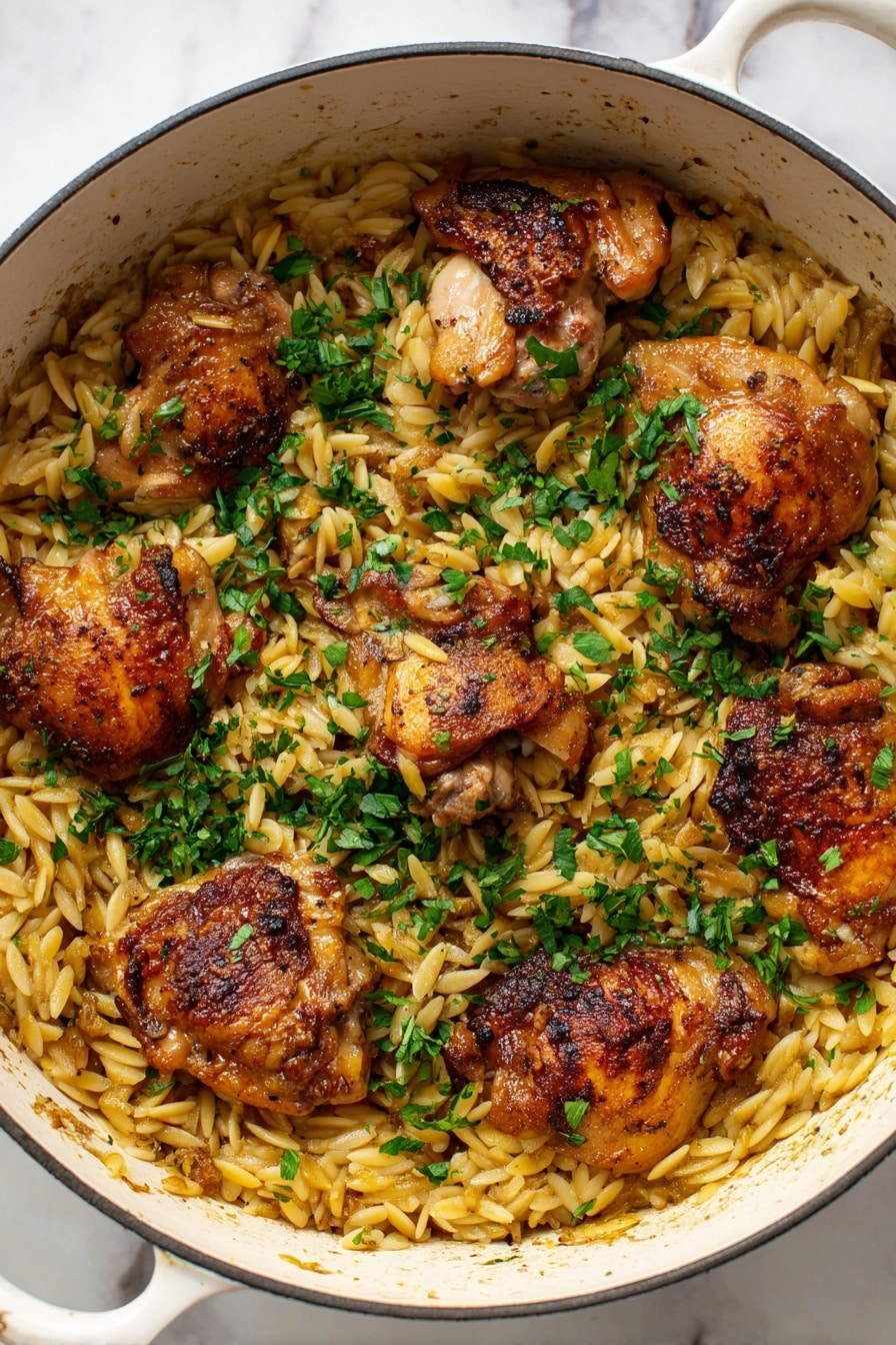 A white pot filled with light golden orzo pasta as the base layer, topped with five crispy browned chicken thighs spread evenly across the pasta. The chicken has a slightly shiny texture from cooking, with a mix of golden and darker brown spots. Bright green chopped herbs are sprinkled generously on top, adding a fresh contrast to the warm tones of the chicken and pasta. The pot sits on a white marbled surface. Photo taken with an iphone --ar 2:3 --v 7 - One Pot Garlic Butter Chicken and Orzo, easy one pot chicken dinner, garlic butter chicken thighs, orzo pasta recipes, quick weeknight chicken meal