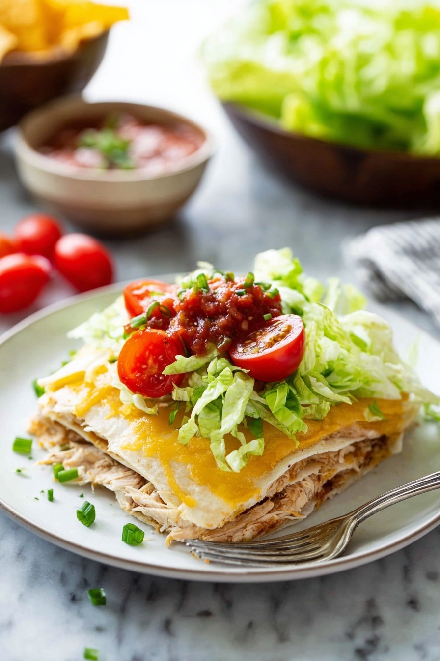 A white plate holds a layered dish with four clear layers: the first layer is a soft tortilla in light beige, topped with shredded cooked chicken in light brown; the second layer is another tortilla; the third is melted golden-yellow cheese with a creamy texture; the fourth layer consists of fresh bright green lettuce, bright red halved cherry tomatoes, green sliced chives, and a small spoonful of chunky red salsa on top. A silver fork lies on the plate's edge. The background shows a white marbled surface with out-of-focus bowls of salsa, chips, and lettuce. Photo taken with an iphone --ar 2:3 --v 7 - Easy Chicken Quesadilla Casserole, Chicken Quesadilla Casserole, cheesy chicken casserole, quick chicken dinner,  easy weeknight casserole