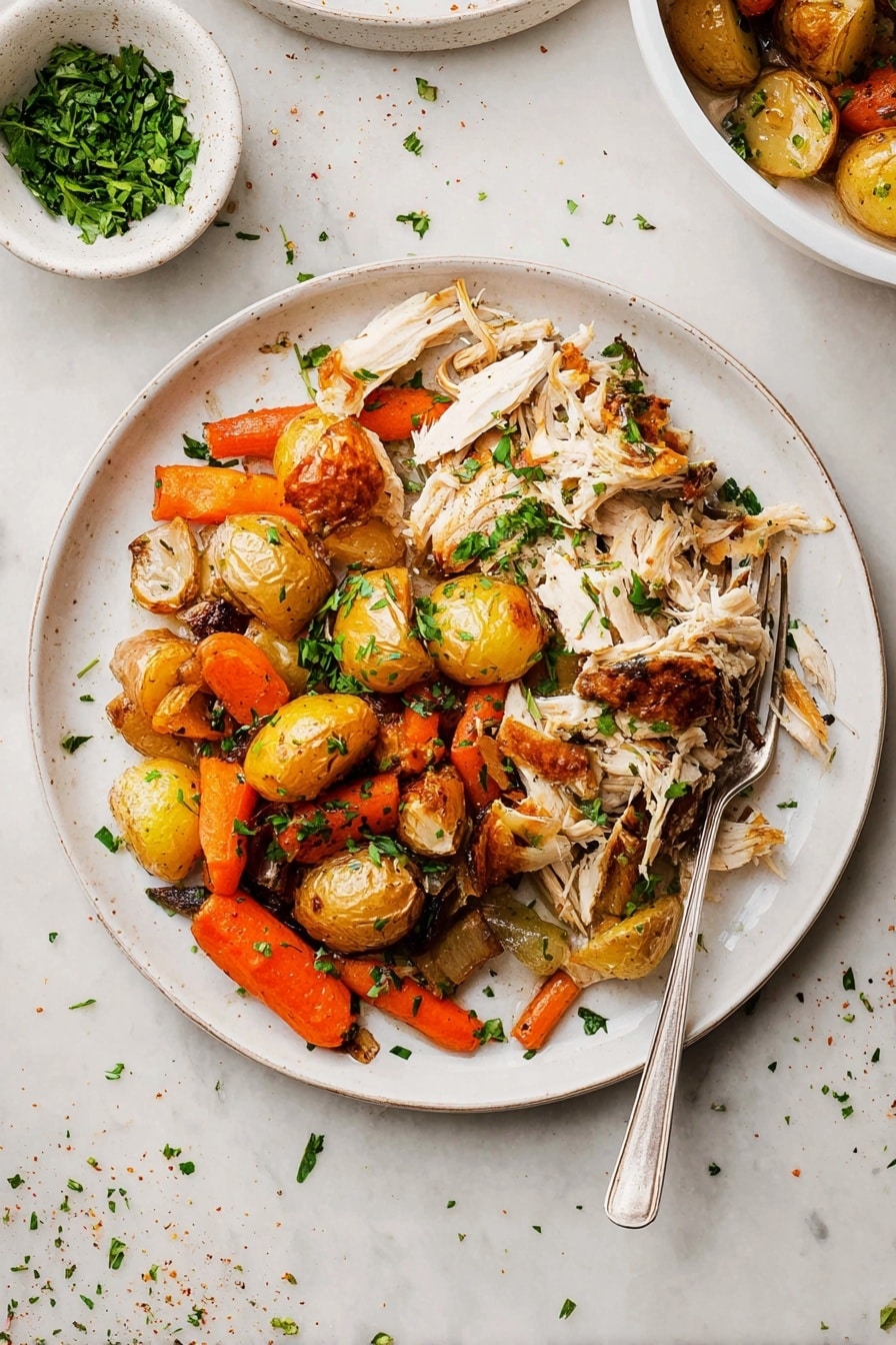 The dish shows a white round plate filled with two main layers: on the left side, there is shredded white meat with golden-brown skin pieces scattered on top, adding texture and color contrast; on the right side, there is a mix of roasted vegetables including small golden-brown potatoes, bright orange carrot pieces, and browned onions, all lightly charred and scattered with chopped green herbs for freshness. A silver fork rests partly on the plate’s edge, pointing inward. Above and behind the plate, a small white bowl with chopped green herbs is visible, placed on a white marbled surface scattered with a few herbs and seasoning bits. Photo taken with an iphone --ar 2:3 --v 7 - Slow Roasted Herb-Infused Whole Chicken, herb roasted chicken recipe, juicy roasted chicken, easy slow roast chicken, flavorful whole chicken