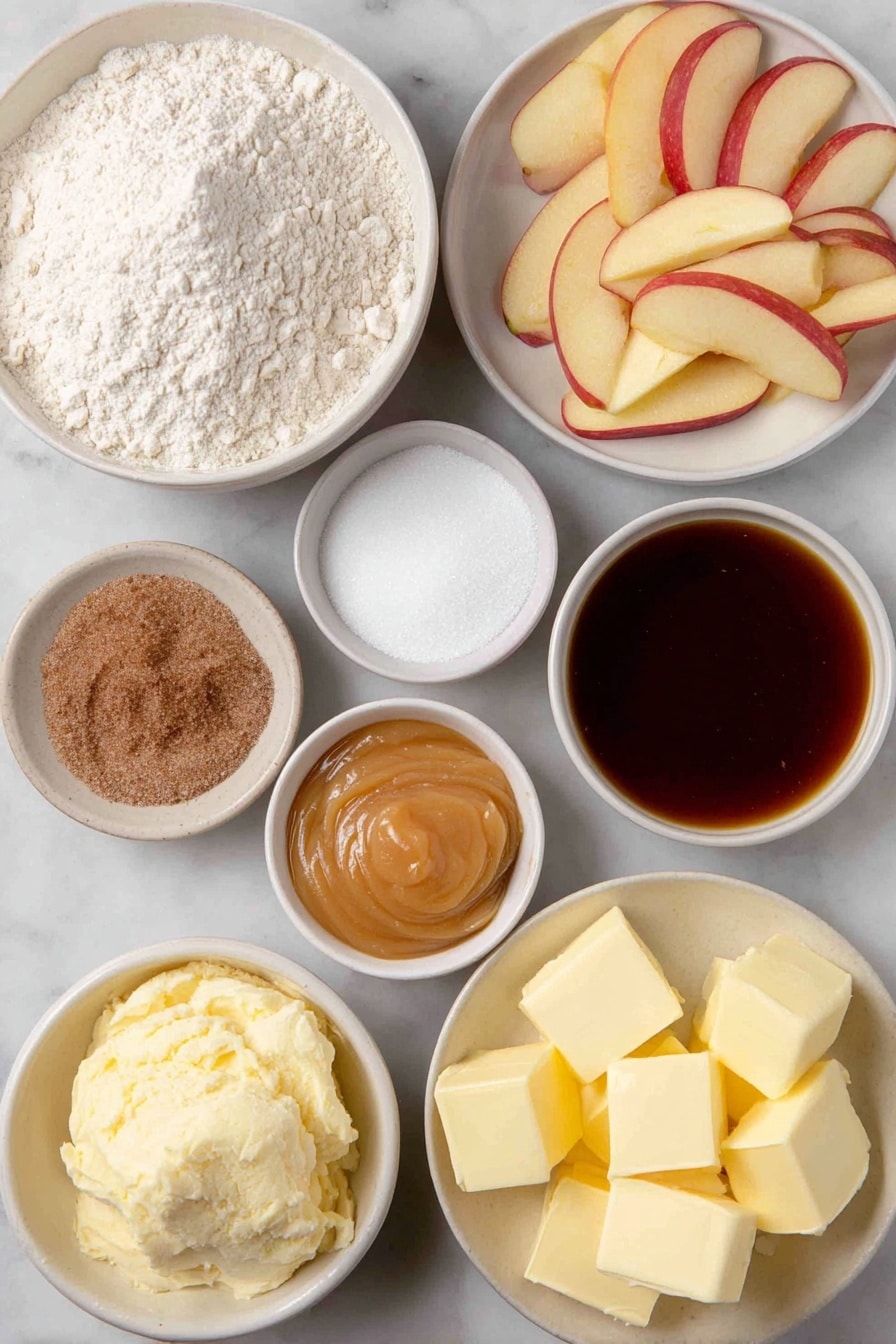 Flat lay of a small mound of all-purpose flour, a few tablespoons of granulated sugar in a small white bowl, a small heap of active dry yeast granules, a pinch of salt in a tiny white bowl, a small white bowl with water, a small white bowl with milk, cubes of fresh butter, several peeled and thinly sliced tart apples arranged neatly, a small white bowl with brown sugar, a small white bowl with caramel ice cream topping, a small white bowl of ground cinnamon, a small white bowl containing a mixture of flour and sugar, and cold butter cubes grouped together, placed on a clean white marble surface, soft natural light, photo taken with an iPhone, professional food photography style, fresh ingredients, white ceramic bowls, no bottles, no duplicates, no utensils, no packaging --ar 2:3 --v 7 --p awthu7i m7354615311229779997 - Apple Dessert Pizza with Cinnamon Apples, Cream Cheese Topping, and Streusel, dessert pizza with apples, cinnamon apple dessert, easy apple dessert, apple streusel pizza, warm apple desserts