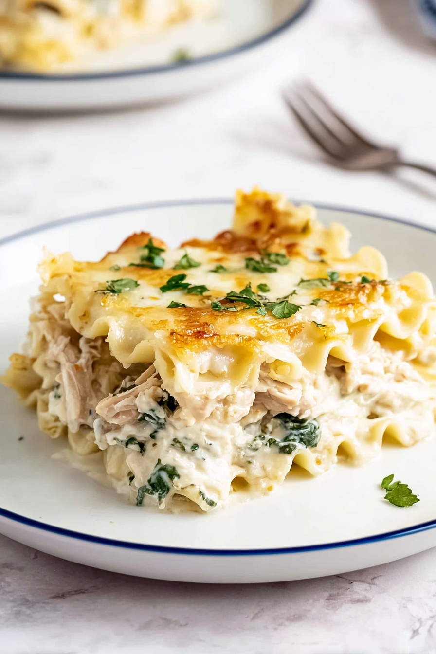 A single piece of lasagna is placed on a white plate with a thin blue rim, showing about four layers. The top layer is light golden with melted cheese and small green parsley flakes scattered on it. Below that is a creamy white sauce mixed with green spinach leaves and chunks of light brown cooked chicken. The pasta layers are soft and wavy, pale yellow in color, separating the cheesy and vegetable layers. The plate is on a white marbled surface with a blurred second plate and a fork in the background. Photo taken with an iphone --ar 2:3 --v 7 - Creamy Chicken Boursin Lasagna, Boursin Cheese Lasagna, Chicken Lasagna with Boursin, Gourmet Chicken Lasagna, Easy Creamy Lasagna