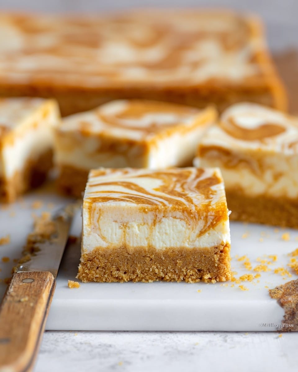 Two square dessert bars are stacked on a white plate with a gold rim, placed on a white marbled surface. Each bar has three layers: a crumbly golden-brown crust at the bottom, a thick smooth creamy white middle layer, and a swirled top layer with light brown and white patterns. There are a few crumbs scattered around the plate. A gold fork rests beside the bars, with two cinnamon sticks nearby in the foreground. The lighting is soft and natural. Photo taken with an iphone --ar 4:5 --v 7