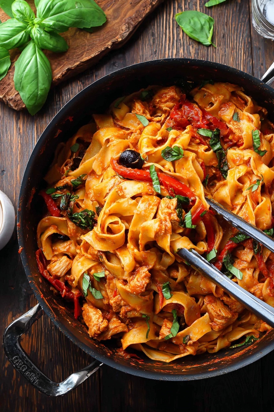 A black pot filled with wide, flat pasta ribbons coated in a rich orange-red tomato sauce mixed with pieces of cooked chicken, strips of red bell pepper, black olives, and green herb leaves scattered around. Metal tongs rest inside the pot, lightly lifting some pasta and chicken. The pot is placed on a dark wooden table with fresh green basil leaves on a wooden board in the background. The scene has a rustic and hearty feel. photo taken with an iphone --ar 2:3 --v 7 - Chicken Cacciatore Pasta, Chicken Cacciatore Italian dish, flavorful chicken pasta, easy chicken pasta recipe, hearty tomato chicken pasta