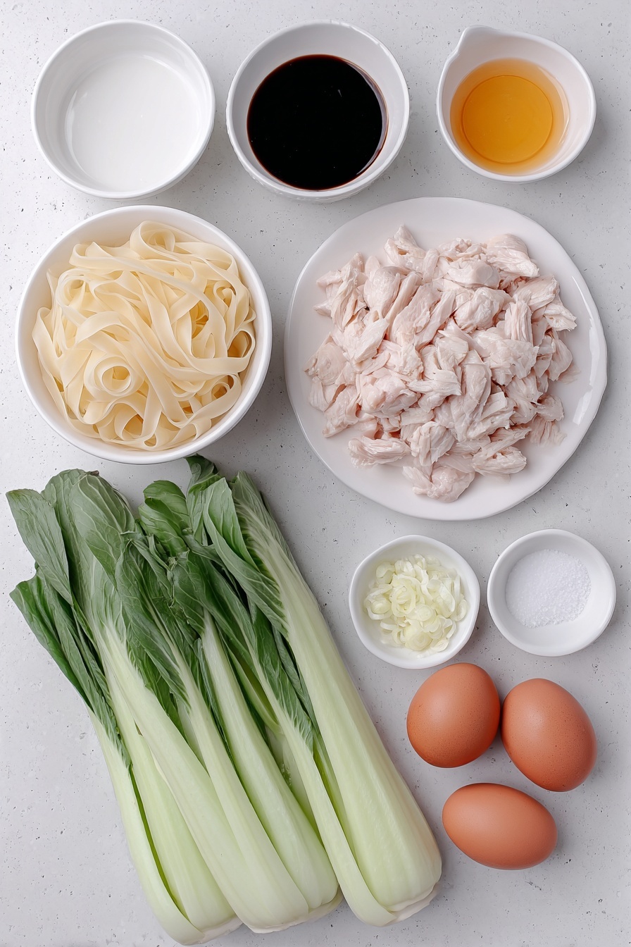 Flat lay of a small pile of fresh wide flat rice noodles (Sen Yai), two small white ceramic bowls containing dark soy sauce and oyster sauce, another small white bowl with light soy sauce, a small white bowl with white vinegar, a small white bowl with sugar crystals, three tablespoons of peanut oil in a small white bowl, two whole uncracked brown eggs, two peeled garlic cloves finely chopped and displayed in a small white bowl, a portion of raw sliced boneless skinless chicken thighs arranged neatly on a simple white ceramic plate, and four fresh Chinese broccoli stems with vibrant green leaves and crisp stalks laid out beside them, all placed on a clean white marble surface, soft natural light, photo taken with an iPhone, professional food photography style, fresh ingredients, white ceramic bowls, no bottles, no duplicates, no utensils, no packaging --ar 2:3 --v 7 --p m7354615311229779997 - Easy Thai Pad See Ew with Chicken, Thai Pad See Ew recipe, chicken stir-fry with wide noodles, quick Thai noodle dishes, authentic Thai street food at home