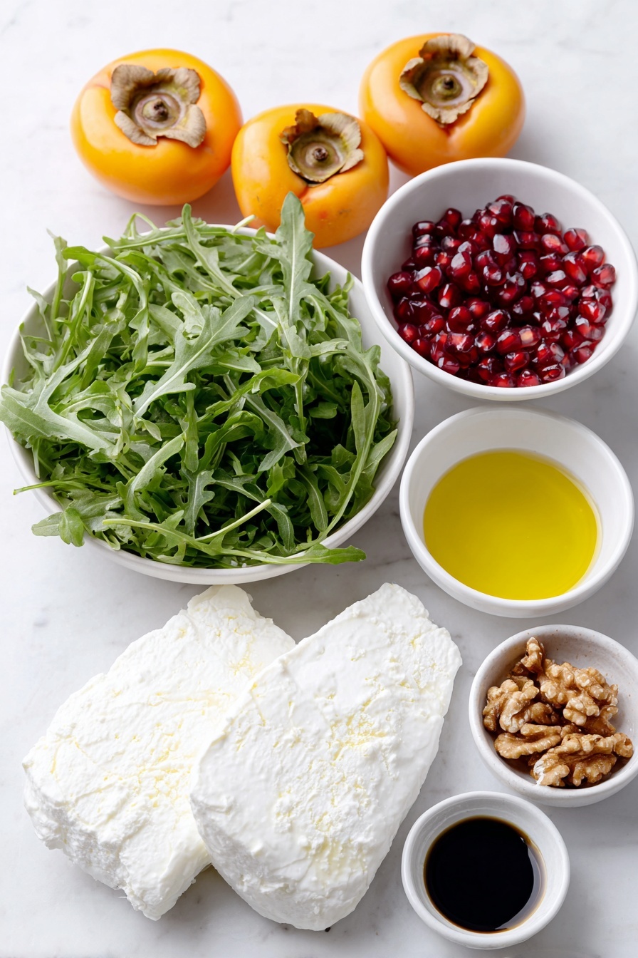 Flat lay of fresh arugula leaves arranged neatly, two whole Fuyu persimmons sliced into wedges showing bright orange flesh, a small pile of raw walnuts with natural textures, torn pieces of creamy white burrata cheese, a small white bowl filled with ruby red pomegranate seeds, and two small white bowls containing dark balsamic vinegar and golden olive oil placed side by side, along with a tiny white bowl of amber maple syrup and a tiny white bowl of fine white salt, all ingredients symmetrically spaced on a clean white marble surface, soft natural light, photo taken with an iPhone, professional food photography style, fresh ingredients, white ceramic bowls, no bottles, no duplicates, no utensils, no packaging --ar 2:3 --v 7 --p m7354615311229779997 - Persimmon Burrata Salad with Balsamic Dressing, seasonal fall salad recipes, easy fruit and cheese salad, quick gourmet salad ideas, healthy appetizer recipes