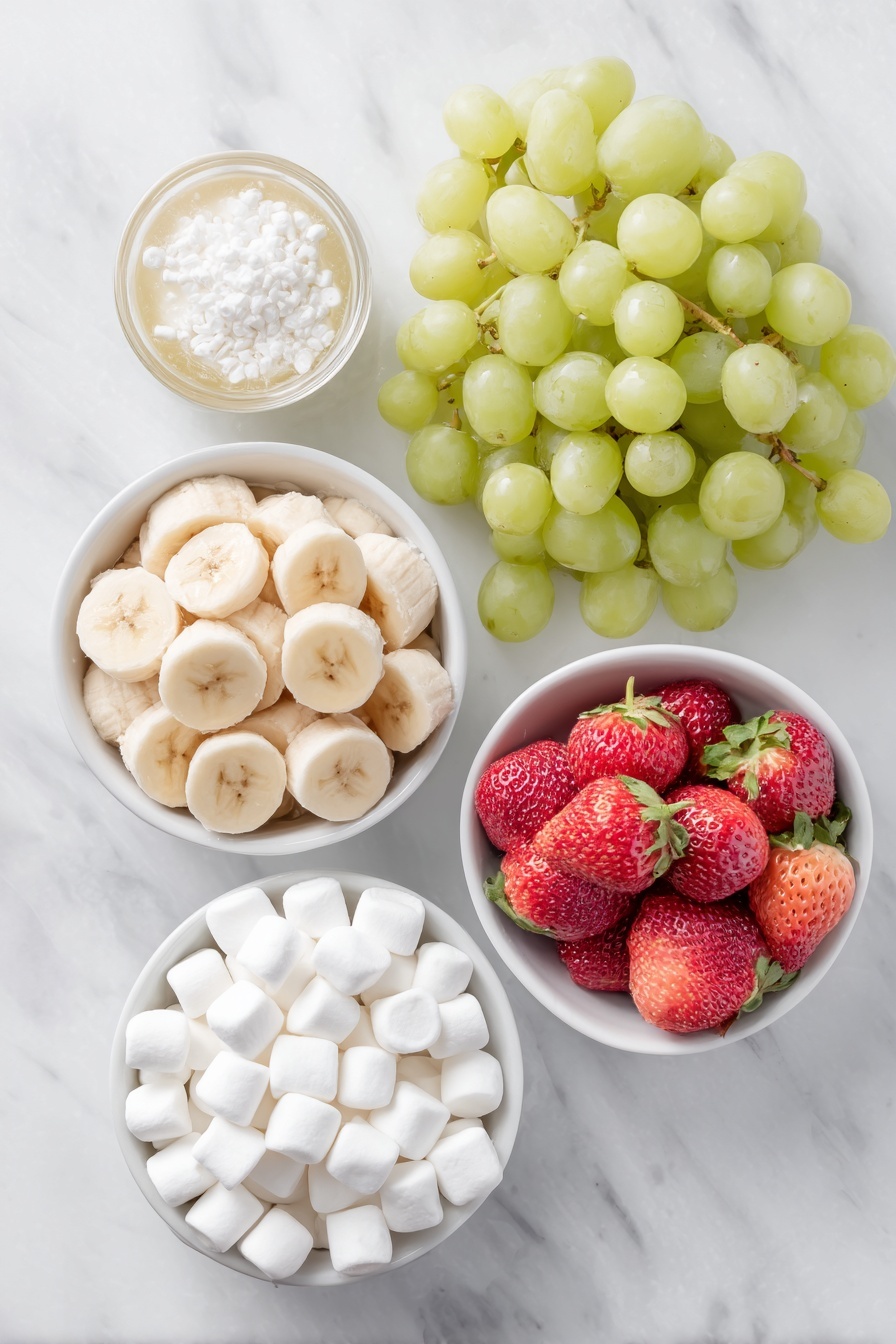 Flat lay of fresh green grapes, a large ripe banana sliced into thick rounds resting in a small white ceramic bowl with a bit of fruit juice, plump red strawberries with hull ends removed, and a small white ceramic bowl filled with white miniature marshmallows, all arranged with perfect symmetry and realistic proportions on a clean white marble surface, soft natural light, photo taken with an iPhone, professional food photography style, fresh ingredients, white ceramic bowls, no bottles, no duplicates, no utensils, no packaging --ar 2:3 --v 7 --p m7354615311229779997 - Grinch Fruit Kabobs, healthy holiday snacks, festive fruit skewers, kids friendly Christmas treats, colorful holiday party ideas