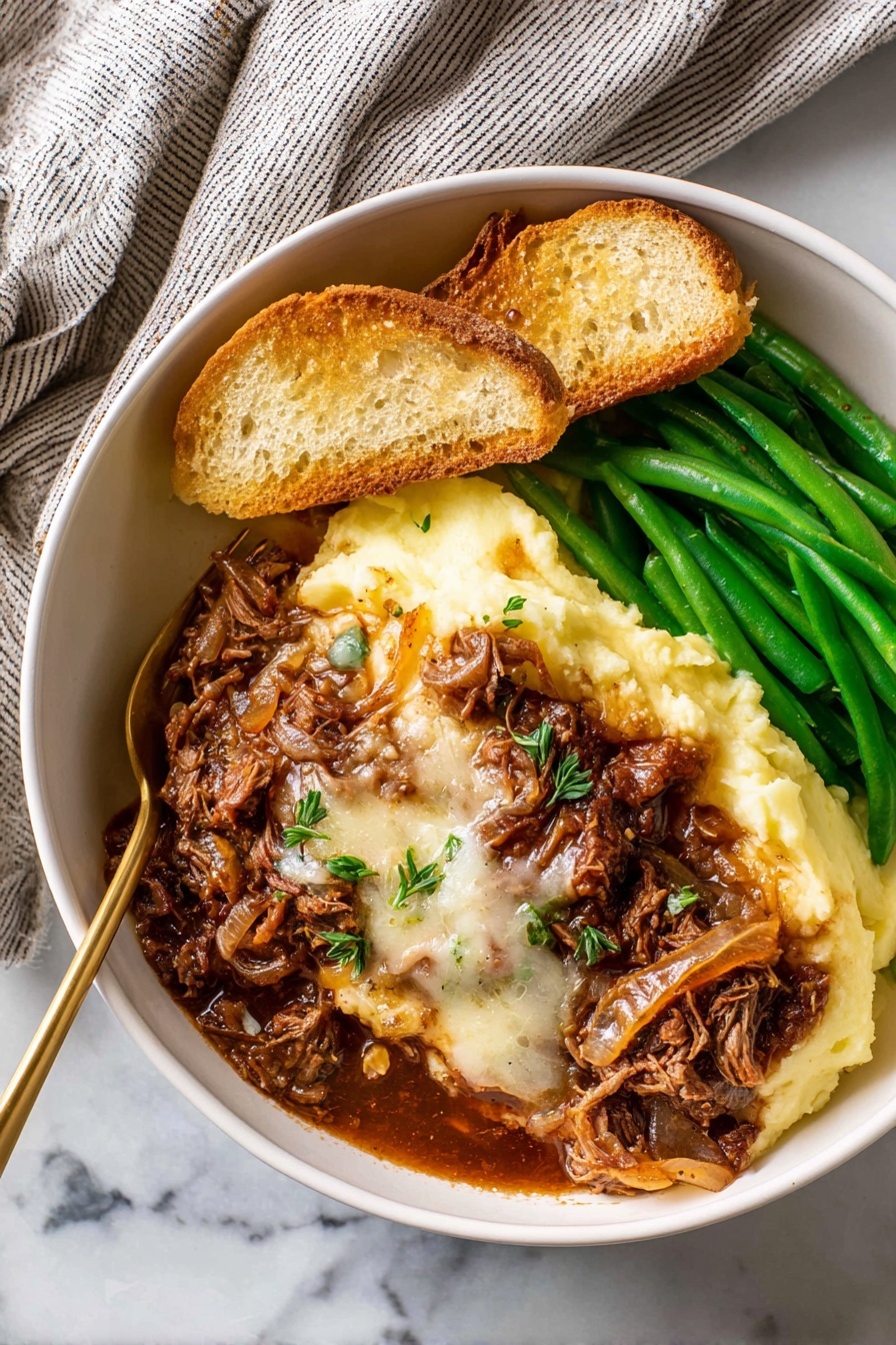 In a white bowl placed on a white marbled surface, there is a dish made of several layers: the bottom left layer is smooth, pale yellow mashed potatoes, topped with a thick layer of rich brown meat with melted white cheese and cooked onions covering the center. To the right, there are bright green cooked green beans stacked neatly. At the top left, two slices of toasted bread rest on the mashed potatoes, all under warm natural light. A golden fork is partly inserted into the mashed potatoes near the meat. A soft, striped towel is seen in the top left corner. Photo taken with an iphone --ar 2:3 --v 7 - French Onion Beef Pot Roast, slow cooker beef roast, caramelized onion pot roast, tender beef roast with onions, French onion inspired beef dish