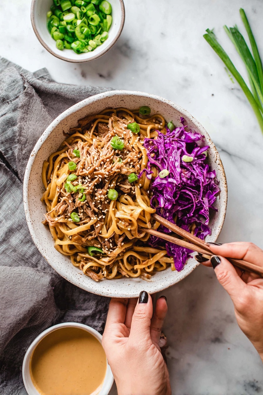 A white speckled bowl filled with a mix of thick, light brown noodles on top, shredded pieces of light brown meat underneath, and bright purple cabbage scattered on the right side and mixed throughout. Light green sliced scallions are sprinkled on top along with small white sesame seeds. A woman's hand holds the bowl from the bottom, while another woman's hand with dark nail polish uses wooden chopsticks to pick up some purple cabbage from the edge of the bowl. Nearby are two small white bowls, one with chopped green scallions and the other with a creamy light brown sauce. The setting is on a white marbled surface with a gray cloth under the bowl, and some scallions lie on the top right side. Photo taken with an iphone --ar 2:3 --v 7 - Thai Peanut Chicken Noodles, Thai peanut chicken stir-fry, quick Thai noodle recipes, easy Thai chicken dishes, creamy spicy noodle dish