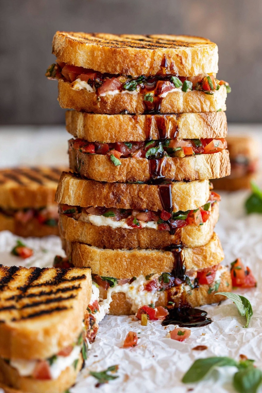 A tall stack of grilled sandwiches with four layers of golden toasted bread, each layer filled with finely chopped red tomatoes, green herbs, and melted light cream cheese, with dark brown balsamic glaze drizzled over the top and sides. The sandwiches show clear grill marks and are placed on crumpled white parchment paper with scattered bits of tomato and herbs around, on a white marbled surface. To the side, a single smaller sandwich with the same fillings is laid down, showing the textured toasted bread and filling clearly. Some green leaves are visible in the foreground. photo taken with an iphone --ar 2:3 --v 7 - Bruschetta Grilled Cheese Sandwiches, Italian bruschetta grilled cheese, tomato basil grilled cheese, easy bruschetta sandwich, melted mozzarella sandwich