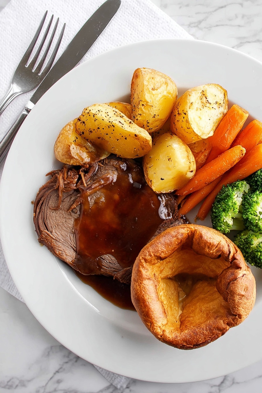 A white plate on a white marbled surface holds a meal with four parts. On the bottom right is a golden brown round Yorkshire pudding with a soft, slightly folded center. Next to it on the left is a thick slice of dark brown roast meat covered in rich, shiny brown gravy sprinkled with coarse black pepper. Above the meat are several light golden roast potatoes with a crispy surface. To the left of the potatoes is a mix of bright orange whole baby carrots and green broccoli florets with a slight shine, showing they are cooked but still fresh. A knife and fork rest on the left side of the plate on a white napkin. Photo taken with an iphone --ar 2:3 --v 7 - Perfect Yorkshire Pudding, Yorkshire Pudding, British Yorkshire Pudding, crispy Yorkshire Pudding, homemade Yorkshire Pudding