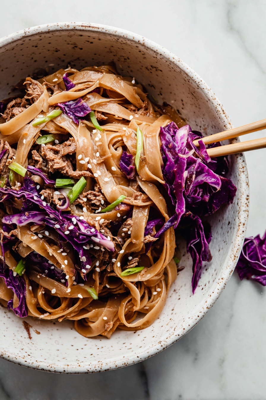 The image shows a white speckled bowl filled with a noodle dish. The bottom layer is made of wide, flat, light brown noodles coated in sauce. Mixed in and on top are shredded pieces of brown cooked meat and thin strips of bright purple cabbage, adding color contrast. Scattered over the dish are small white sesame seeds and green sliced scallions for garnish. A pair of chopsticks rests inside the bowl on the right side, holding some purple cabbage and noodles. The bowl is placed on a surface with a white marbled texture, and a small piece of purple cabbage is nearby. photo taken with an iphone --ar 2:3 --v 7 - Thai Peanut Chicken Noodles, Thai peanut chicken stir-fry, quick Thai noodle recipes, easy Thai chicken dishes, creamy spicy noodle dish