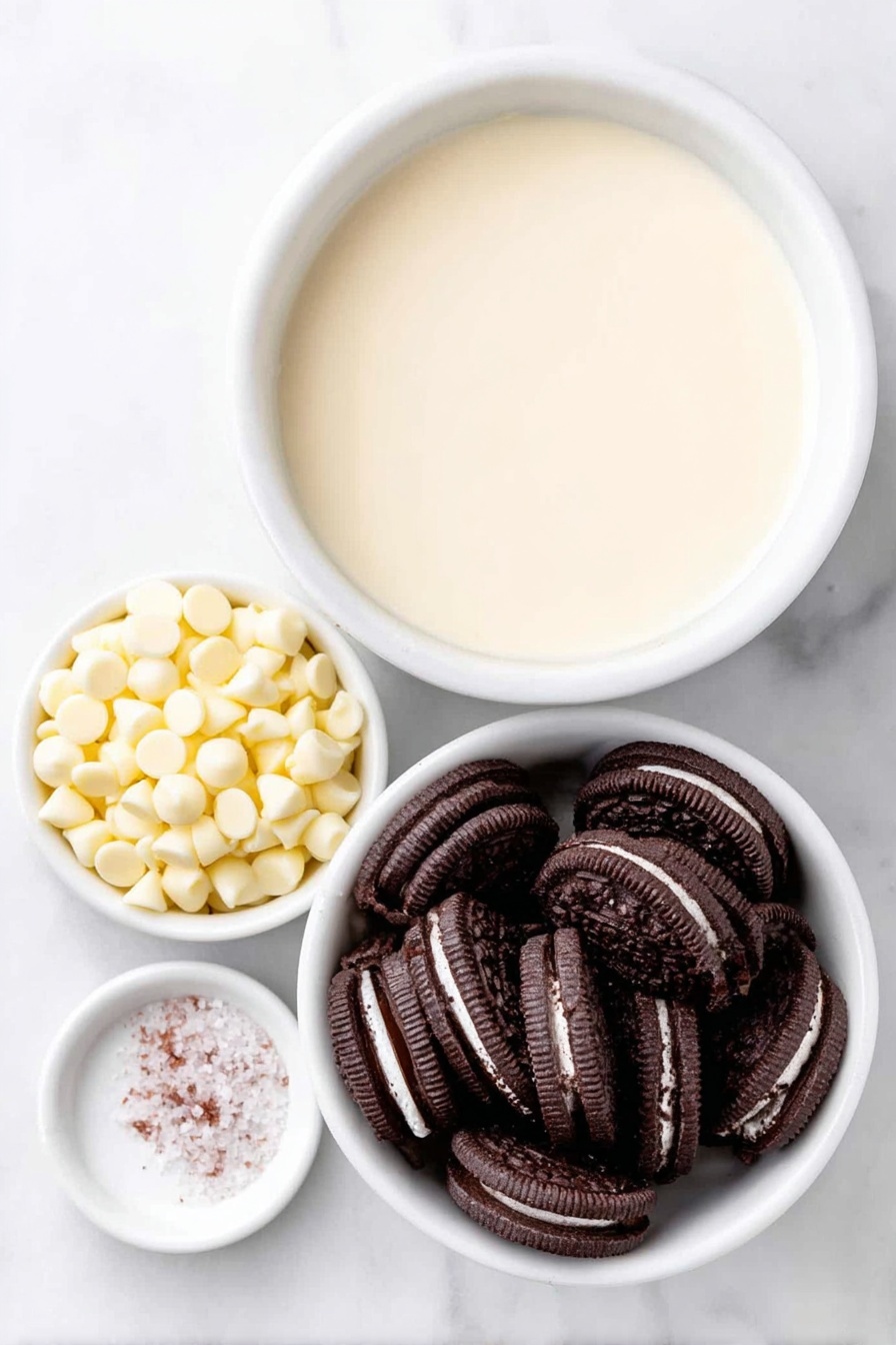 Flat lay of a small mound of glossy white chocolate chips, a simple white ceramic bowl filled with smooth, creamy condensed milk, a neat pile of crushed black-and-white Oreo cookie pieces showing the chocolate cookie and creamy filling contrast, and a tiny pinch of coarse white sea salt on a white ceramic spoon rest, all arranged in perfect symmetry placed on a clean white marble surface, soft natural light, photo taken with an iPhone, professional food photography style, fresh ingredients, white ceramic bowls, no bottles, no duplicates, no utensils, no packaging --ar 2:3 --v 7 --p m7354615311229779997 - White Chocolate Oreo Fudge, Oreo fudge recipe, easy Oreo fudge, no-bake Oreo fudge, creamy Oreo fudge