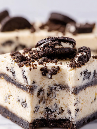 This image shows a close-up of a square dessert made of four thick layers. The base layer is creamy white with bits of dark brown cookie mixed inside. Above this is a thin, even layer of dark brown cookie pieces. The next layer is another thick creamy white layer with small cookie bits scattered throughout. The top layer is a smooth cream color studded with large crumbled pieces of dark brown cookie, some sitting on the surface. The dessert sits on a white marbled surface, and one edge shows a bite taken out. The texture looks soft and slightly firm. Photo taken with an iphone --ar 2:3 --v 7 - White Chocolate Oreo Fudge, Oreo fudge recipe, easy Oreo fudge, no-bake Oreo fudge, creamy Oreo fudge