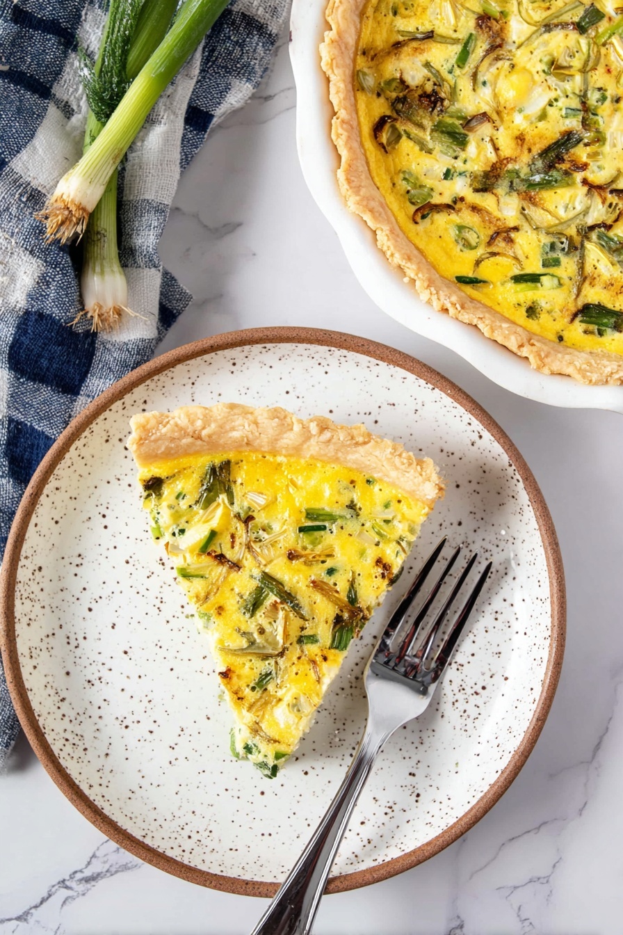A slice of yellow quiche with green vegetable pieces and light brown cooked bits sits on a white speckled plate with a brown edge, showing a soft, custard-like texture on top and a light golden crust on the bottom. Near the plate is a silver fork with a shiny surface lying on a white marbled table. Above and to the right, part of the whole quiche is visible in a white dish, showing a similar uneven yellow surface with green vegetable pieces embedded and a lightly browned crust. A blue and white checkered cloth with some green stalks peeks from the upper left corner on the white marbled table. Photo taken with an iphone --ar 2:3 --v 7 - Asparagus and Leek Quiche with Gruyère, asparagus leek quiche, savory vegetable quiche, brunch recipe with asparagus, cheesy leek tart