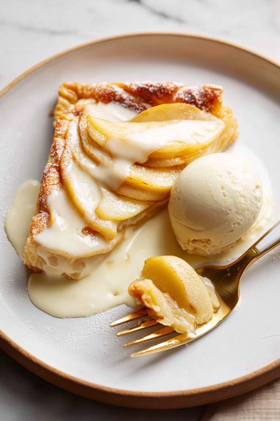 A white plate on a white marbled surface holds a dessert with two main layers. The bottom layer is a golden-brown, flaky pastry crust with visible puffed edges. On top, there is a layer of thin, pale yellow cooked apple slices arranged carefully. Part of the dessert is covered with a creamy white sauce that is melting slightly. A round scoop of light beige ice cream sits next to the dessert, partially covered by the sauce. A gold and white knife and a silver fork are placed on the plate, with the fork lifting a piece of the dessert. Photo taken with an iphone --ar 2:3 --v 7 - French Apple Tart with Puff Pastry, apple tart recipes, French dessert ideas, how to make apple tart, easy apple tart dessert
